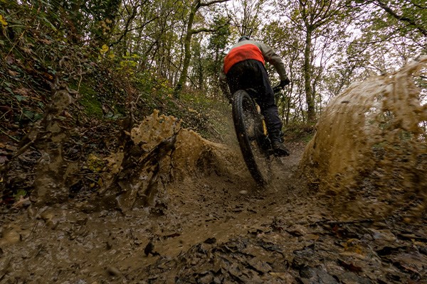 mountain biker riding through water